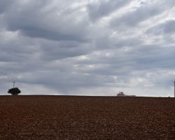 Mike Coffey drills hard red winter wheat in advance of hoped-for fall rains.
